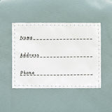 The inside label of the Lassig 'About Friends' tiny backpack in light pink.