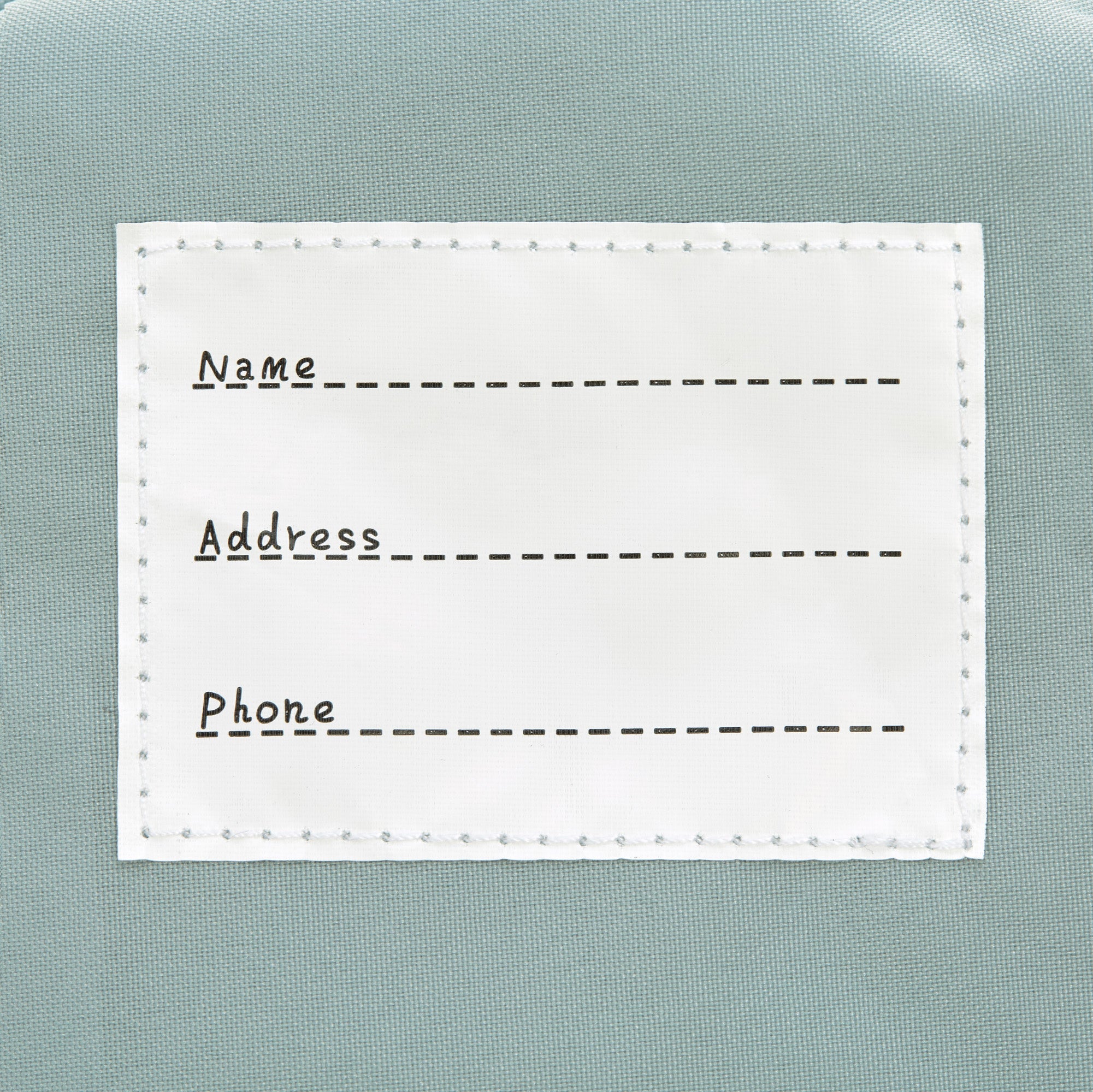 The inside label of the Lassig 'About Friends' tiny backpack in light pink.