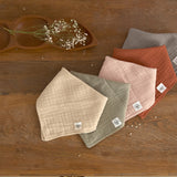 Five different coloured Lassig muslin dribble bibs.