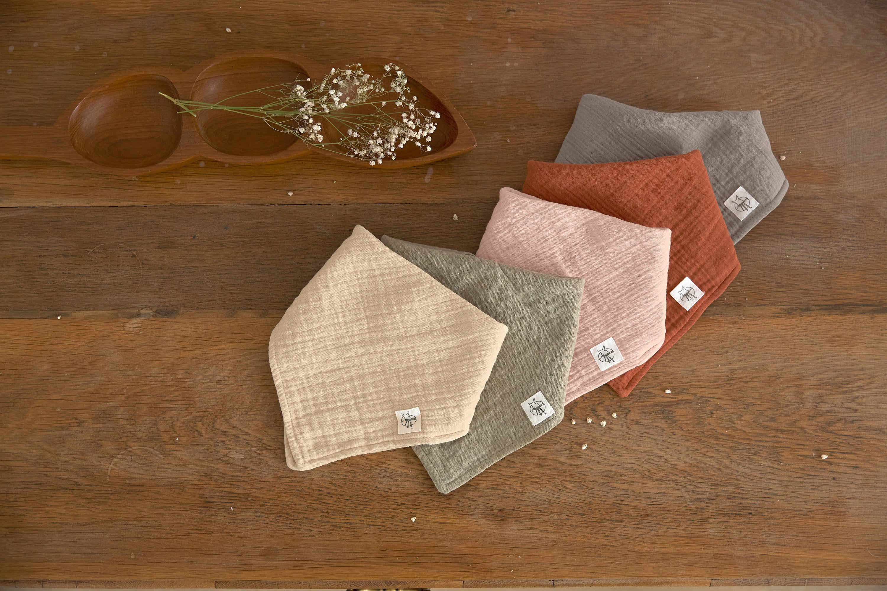 Five different coloured Lassig muslin dribble bibs.