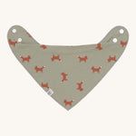 The Lassig organic cotton bandana dribble bib, in a soft green colour with little foxes printed all over. It has white popper fastenings. 