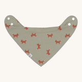 The Lassig organic cotton bandana dribble bib, in a soft green colour with little foxes printed all over. It has white popper fastenings. 