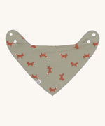The Lassig organic cotton bandana dribble bib, in a soft green colour with little foxes printed all over. It has white popper fastenings. 