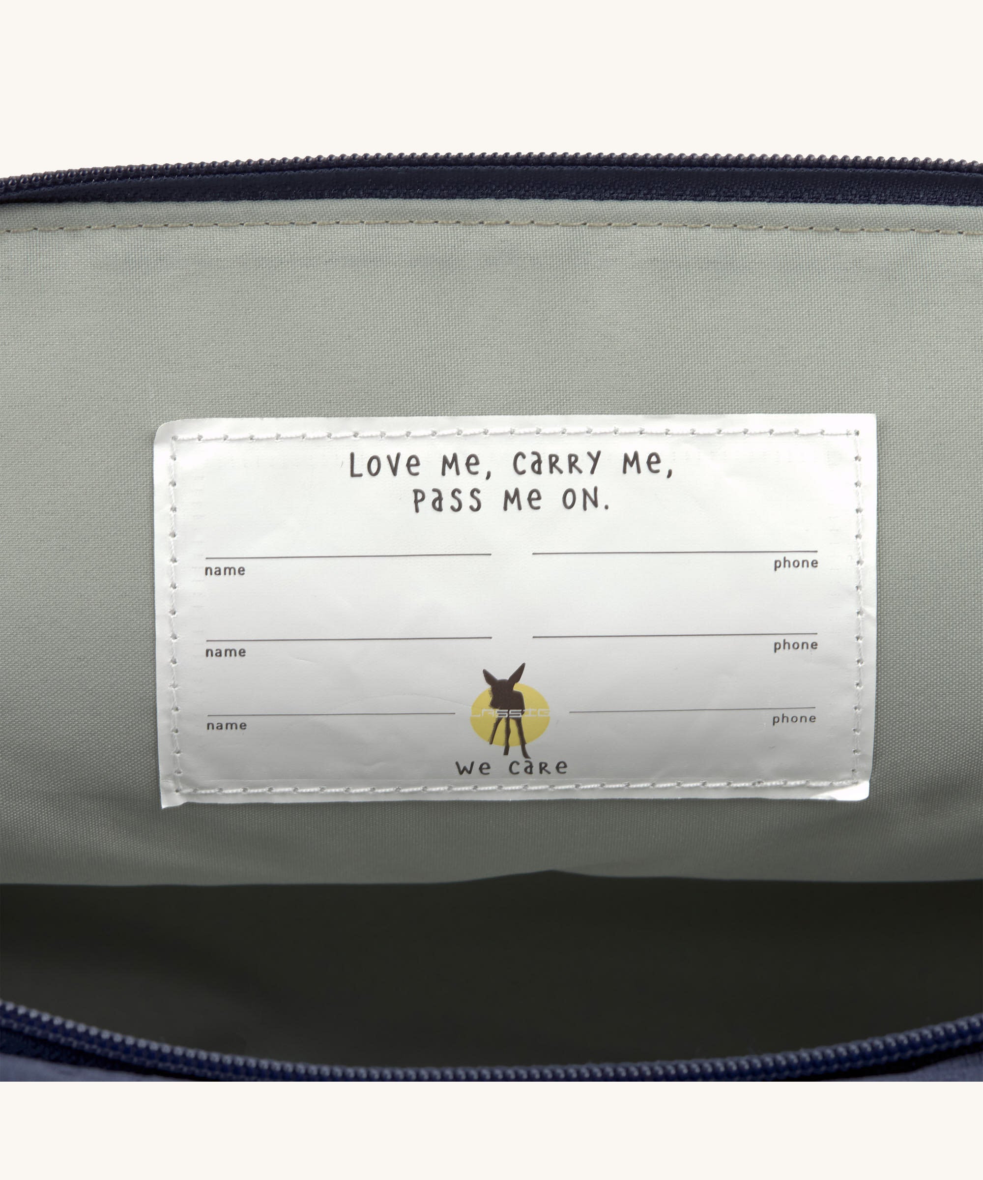 The name badge inside the Lassig Medium Rolltop Backpack in a Little Gang Navy colour design. These roll top bags are available in different colours and sizes at Babipur.