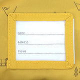 The name label on the inside of the Lassig kids mini campervan backpack, with a yellow lining with a campervan pattern. 