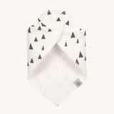 The Lassig organic cotton bandana bib in white with grey triangles, wrapped around and fastened with the popper fastenings. 