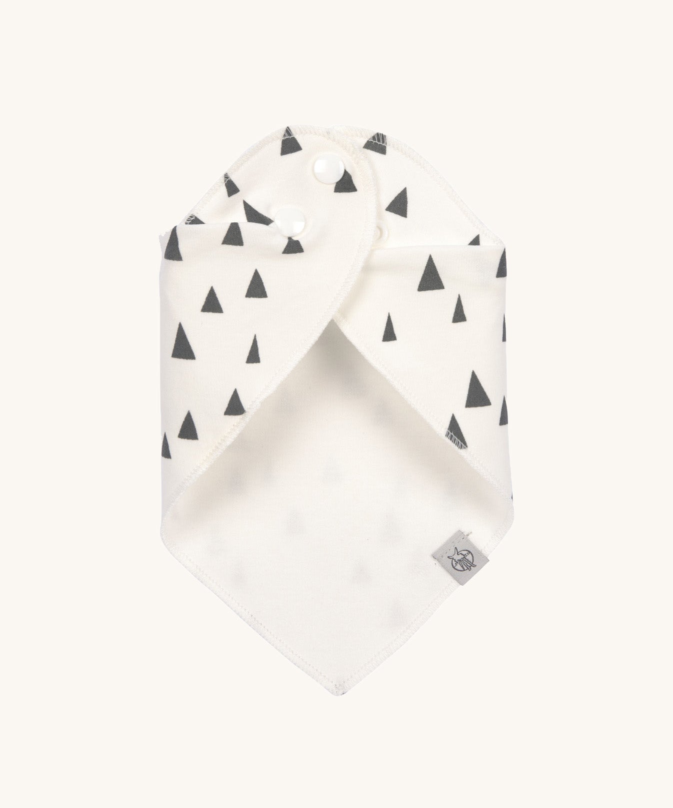 The Lassig organic cotton bandana bib in white with grey triangles, wrapped around and fastened with the popper fastenings. 