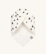 The Lassig organic cotton bandana bib in white with grey triangles, wrapped around and fastened with the popper fastenings. 