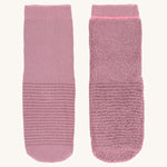 The Lassig organic cotton baby and toddler anti-slip grippy socks, one is inside out to show the fluffy inside.