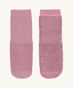 The Lassig organic cotton baby and toddler anti-slip grippy socks, one is inside out to show the fluffy inside.
