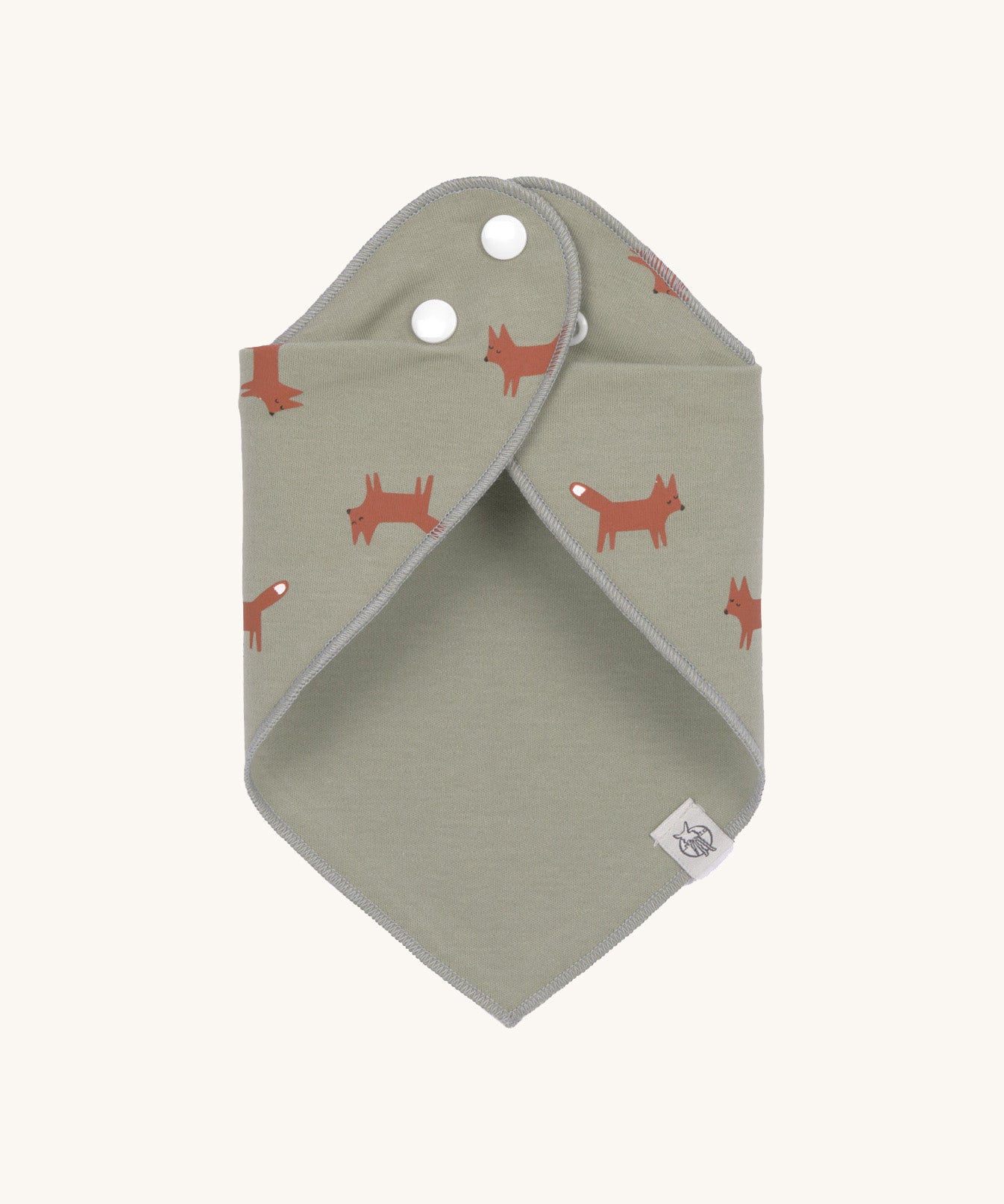 The Lassig Little Fox print organic cotton bandana bib, wrapped around and fastened with the popper fastenings. 
