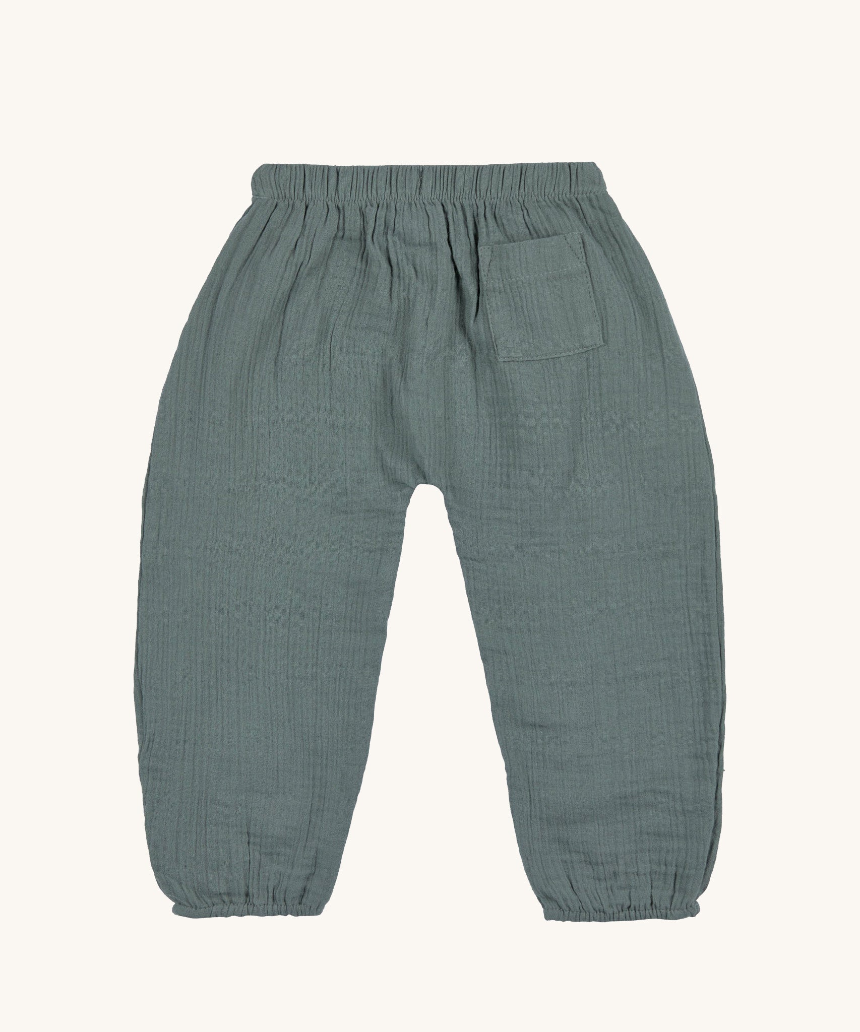The back of the Lassig organic cotton muslin trousers for babies and toddler, in petrol green. 