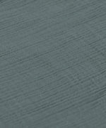 A closeup of the lovely organic cotton muslin material in petrol green. 
