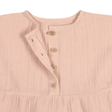 A closeup of the brown buttons on the Lassig organic cotton muslin dress for babies and toddlers in a pretty powder pink colour.
