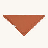The Lassig organic cotton muslin bandana dribble bib in a lovely orange rust colour