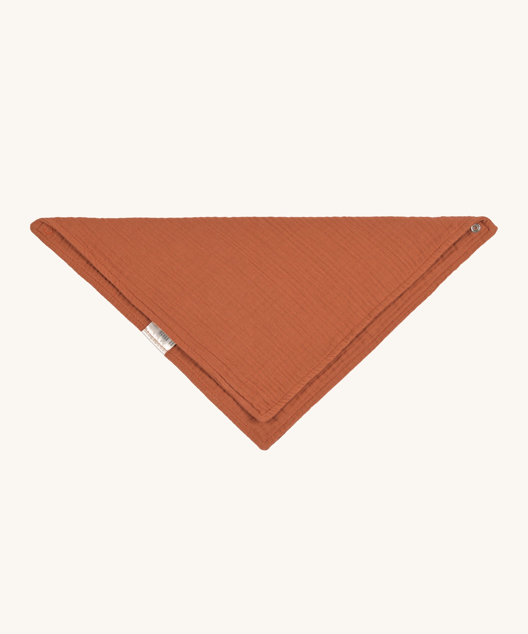 The Lassig organic cotton muslin bandana dribble bib in a lovely orange rust colour