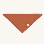 The Lassig organic cotton muslin bandana dribble bib in a lovely orange rust colour