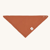 The Lassig organic cotton muslin bandana dribble bib in a lovely orange rust colour