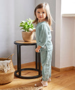 A little girl wearing the Lassig organic cotton muslin long sleeved shirt for babies and toddlers, in a silver grey