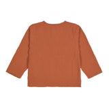 The back of the Lassig organic cotton muslin shirt for babies and toddlers, in a bright orange rust colour.