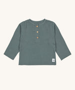 The Lassig organic cotton muslin long sleeved top for babies and toddlers, in a dark petrol green with little brown buttons.