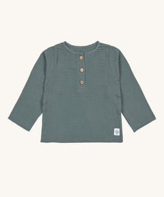 The Lassig organic cotton muslin long sleeved top for babies and toddlers, in a dark petrol green with little brown buttons.