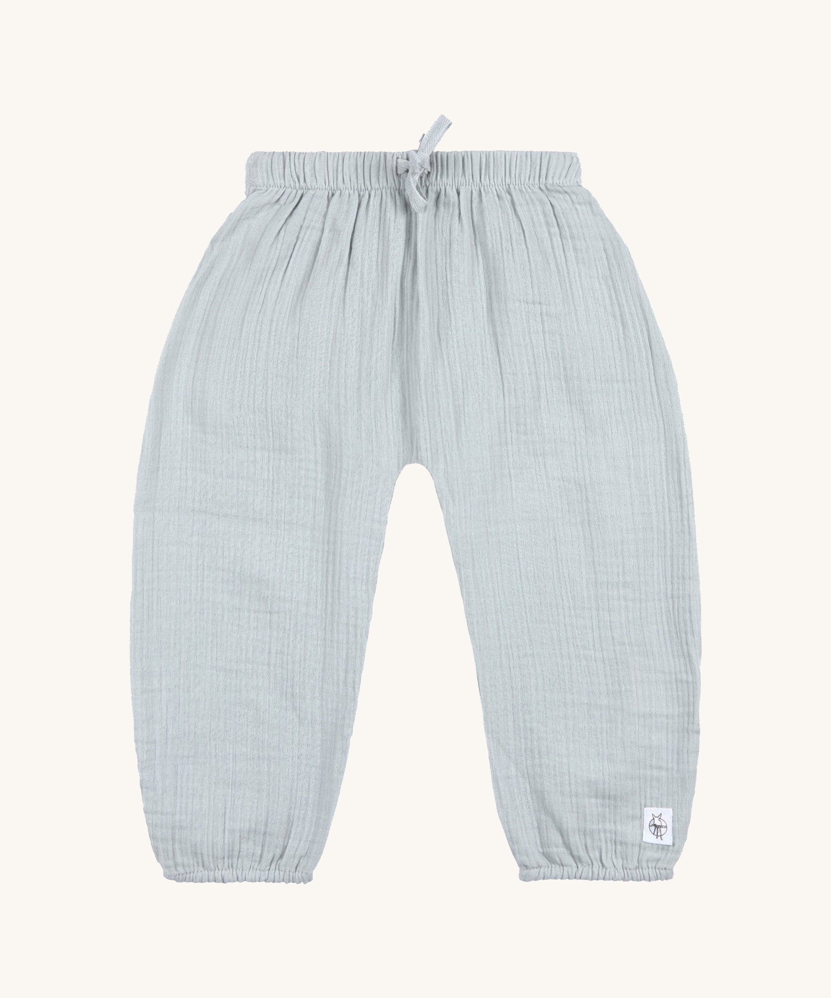 The Lassig organic cotton muslin baby and toddler trousers, in a light powder blue colour. 