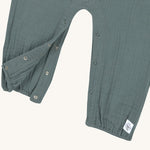A closeup of the push-snap fastenings around the crotch and leg area, for easy dressing. 