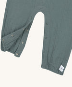 A closeup of the push-snap fastenings around the crotch and leg area, for easy dressing. 