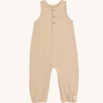 The Lassig organic cotton muslin baby and toddler jumpsuit in a natural cream colour, with little cream buttons at the neck.