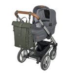The Lassig Rolltop Up nappy change backpack in olive green, attached to a pram with the included clips.