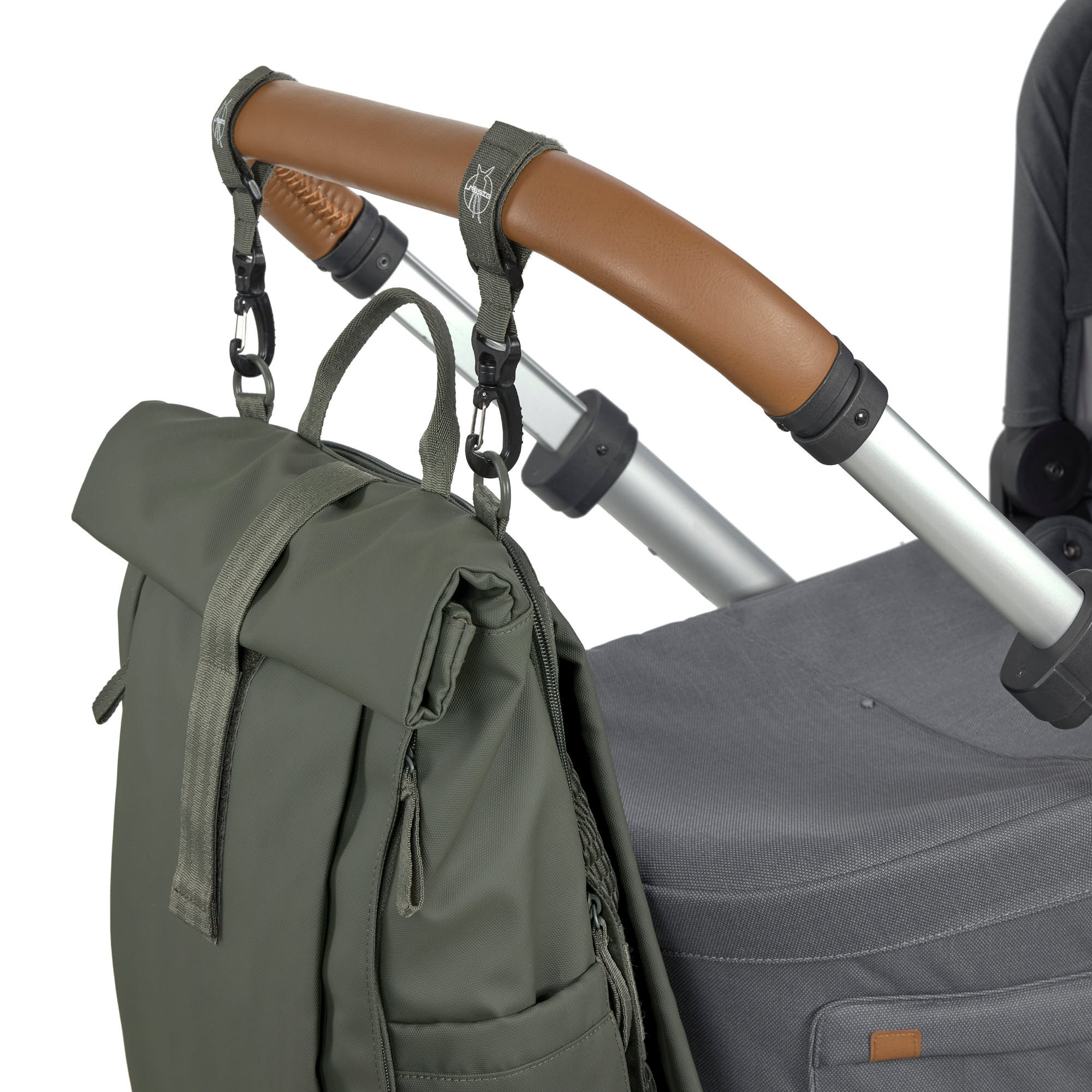 The Lassig Rolltop Up nappy change backpack in olive green, attached to a pram with the included clips.