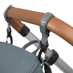The Lassig Slender Up nappy change backpack in reflective anthracite, attached to a pram with the included pram clips.
