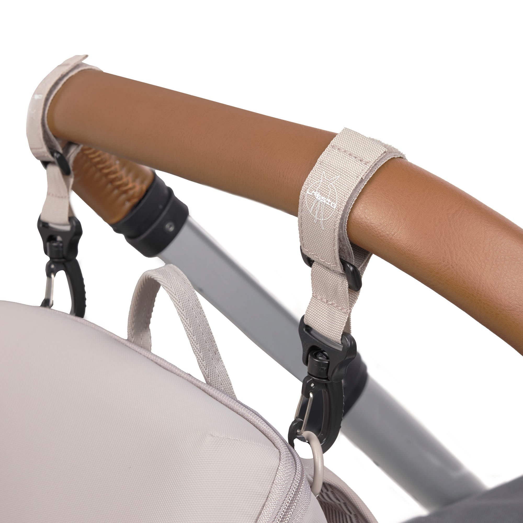 The Lassig Slender Up nappy change backpack in Taupe, attached to a pram with the included pram clips.