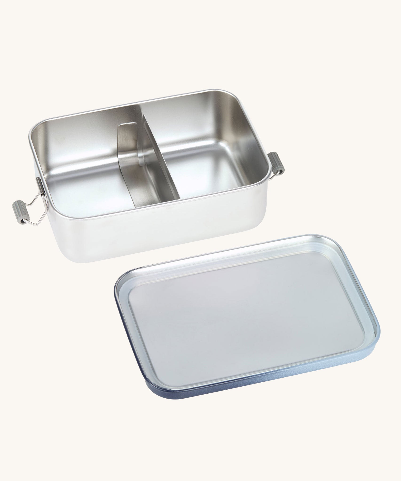 The Lassig Stainless Steel Lunchbox with a Unique Dark Blue lid show with the lid off and divider in place in the box. This lunch box has a removable divider. 