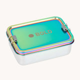 Lassig Stainless Steel Lunchbox in a  Solid Bold Rainbow design. A stainless steel lunchbox with removable divider featuring an iridescent rainbow coloured lid. This lunchbox is part of a wide range of reusable items available at Babipur. 