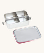 The Lassig Stainless Steel Lunchbox in a Unique Berry Rose colour shown with the lid taken off. This stainless steel lunch box has a removable divider.