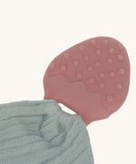 A closeup of the strawberry-shaped natural rubber teether. 