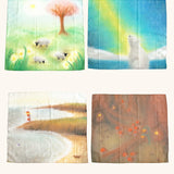 laura's play cotton seasonal set,  different play cloths laid out with artwork representing spring, summer autumn and winter