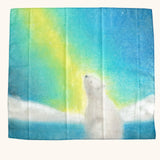 winter play cloth with a polar bear looking up at the northern lights from an icy landscape