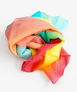Laura's play cotton pastel rainbow gradient playcloth, made from 100% organic cotton ruffled up into a pile