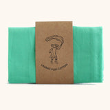 Laura's 100% organic cotton small play cloth in green held together by a decorated cardboard strip