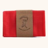 Laura's 100% organic cotton small play cloth in red held together by a decorated cardboard strip