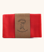 Laura's 100% organic cotton small play cloth in red held together by a decorated cardboard strip