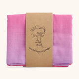 Laura's Play Cotton unicorn pink gradient playcloth, made from 100% organic cotton held by a decorative cardboard strip