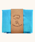 Laura's Play Cotton water blue gradient playcloth, made from 100% organic cotton held by a decorative cardboard strip