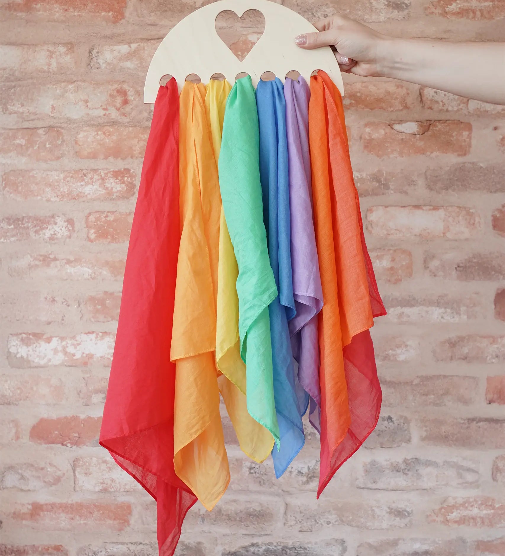 Laura's Play Cotton large Wooden Display holder with heart cut out with 7 play cloths inside.