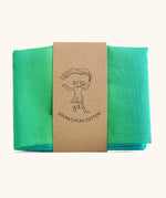 Laura's Play Cotton woods green gradient playcloth, made from 100% organic cotton held by a decorative cardboard strip