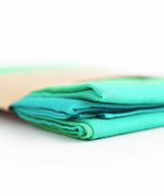 Laura's play cotton woods green gradient playcloth, made from 100% organic cotton laid flat showing corner