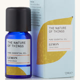 Organic lemon pure essential oil in a blue glass bottle in front of a decorative blue cardboard box.